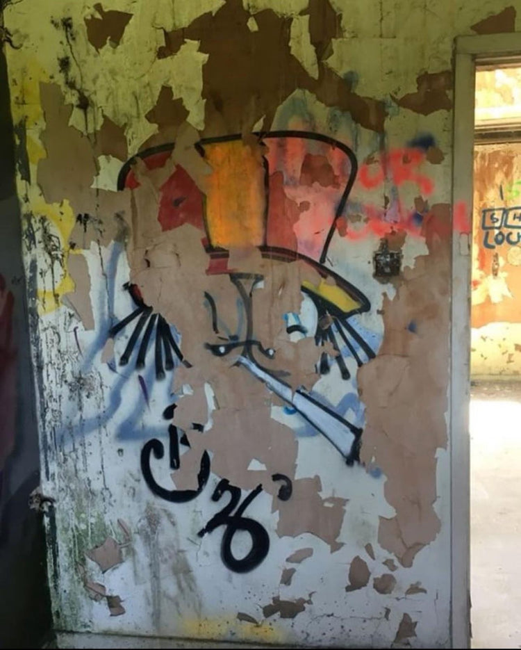 Dready character painted on a weathered door