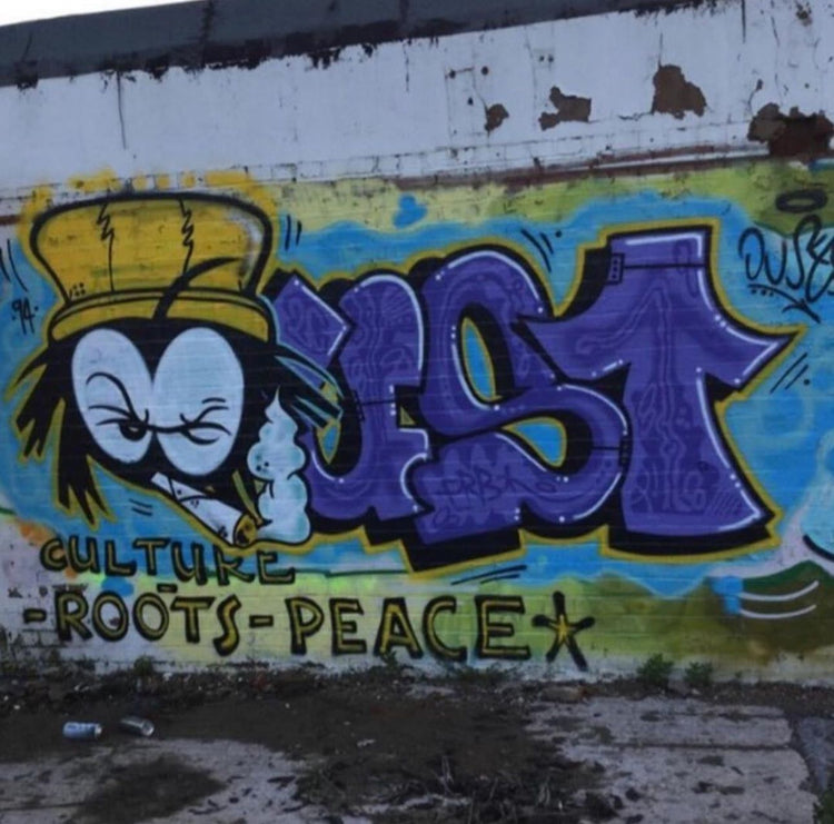 Dready mural with Culture Roots Peace lettering